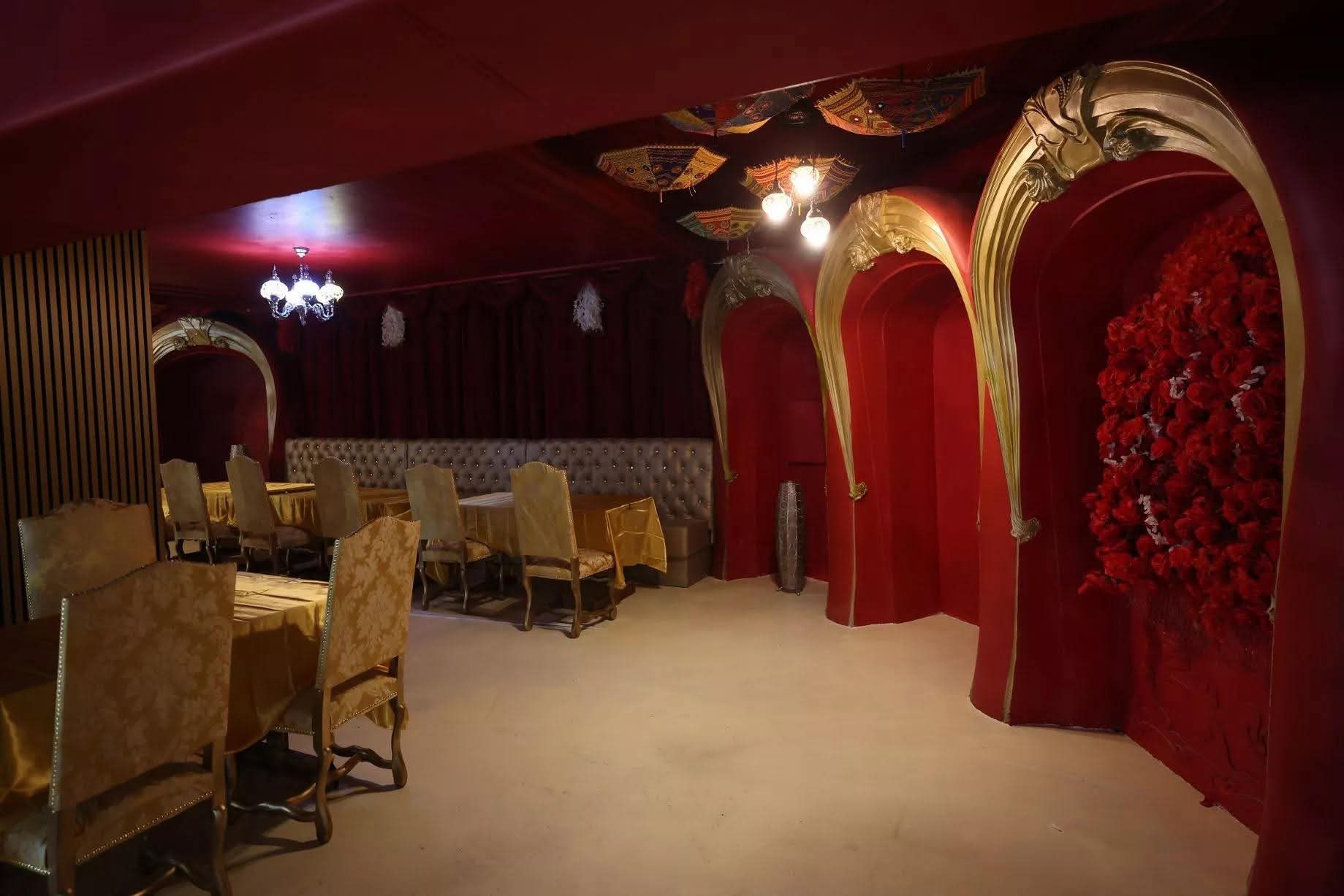 VIP dining area with golden arches and red decor